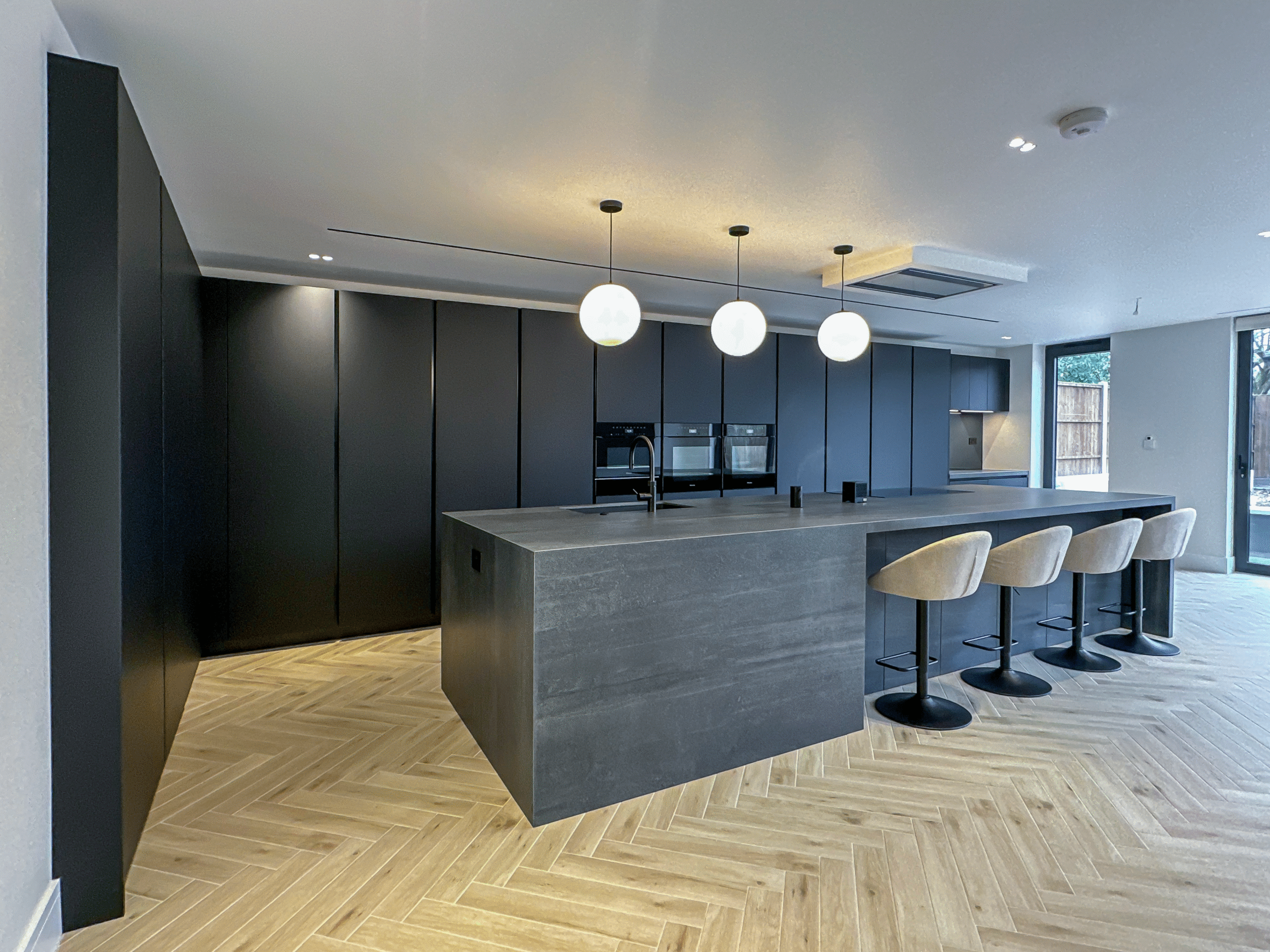 Image of a modern black kitchen with island